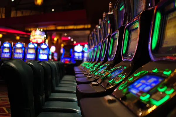 A woman in a luxurious green gown next to an ornate roulette wheel, capturing the upscale casino mood of 7555BEF.