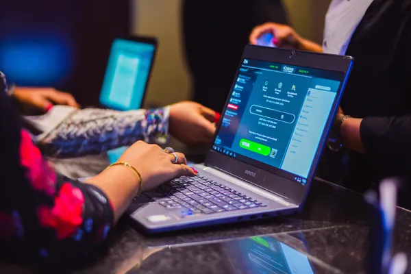 7555BEF Login — Instantly access your secure account A confident dealer surrounded by casino chips inviting players to access their 7555BEF account, reflecting quick and easy login options.
